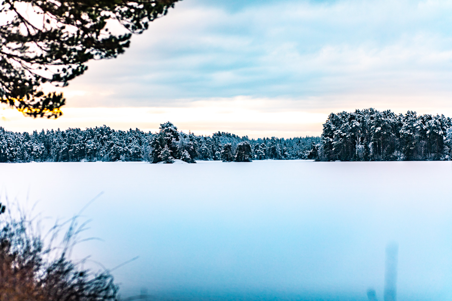 Vy över is- och snötäckta Nävsjön under vintern